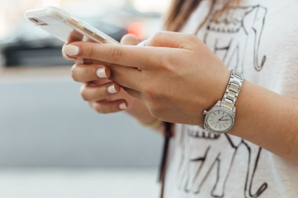 Smartphone - woman holding iPhone during daytime