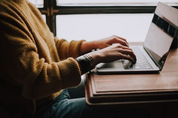 Laptop - person sitting front of laptop