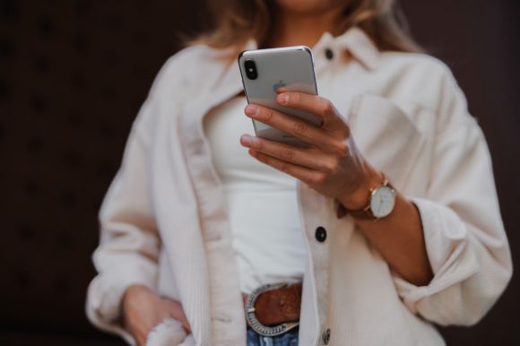 Smartphone - woman in white coat holding silver iphone 6