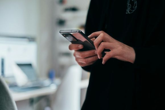 Smartphone - person holding black android smartphone