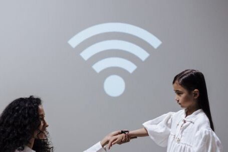 Wi-Fi - Mother and daughter with smartwatch and Wi-Fi symbol