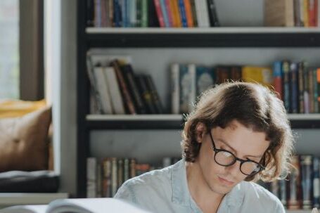 E-Readers - A Diligent Male Student Reading a Book