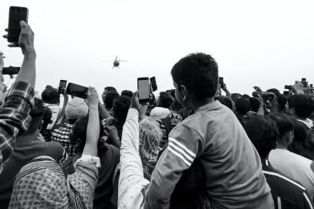 360-Degree Cameras - A black and white photo of people holding up their phones