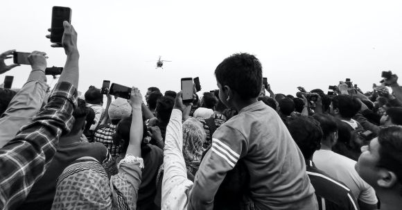 360-Degree Cameras - A black and white photo of people holding up their phones