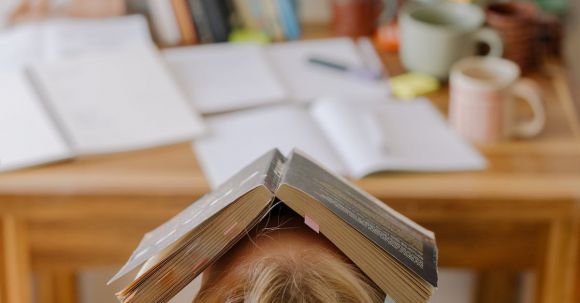 E-Readers - Person in White Shirt With Brown Wooden Frame