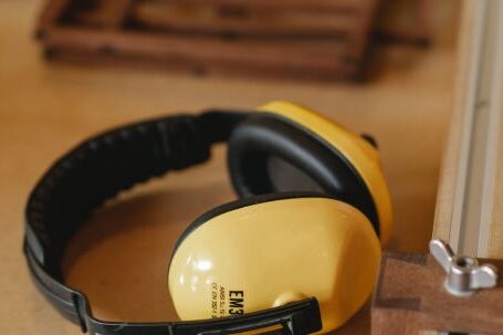 Noise-Canceling Headphones - Protective headphones for woodwork on wooden table