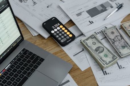 Wearable Payment Devices - Banknotes and Calculator on Table