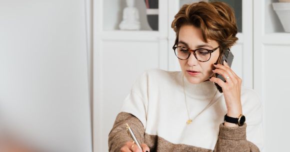 Prescription Smart Glasses - Modern businesswoman in casual outfit talking on mobile in office