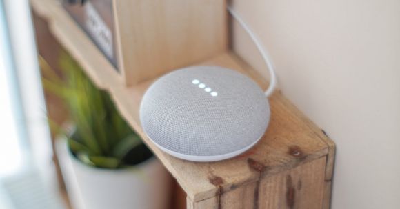 Voice Assistant - Round Grey Speaker On Brown Board