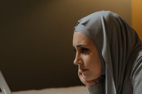 Smart TVs Streaming - Woman in Gray Hijab Using Macbook Air