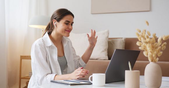 Wireless Earbuds - Cheerful woman having video call via laptop