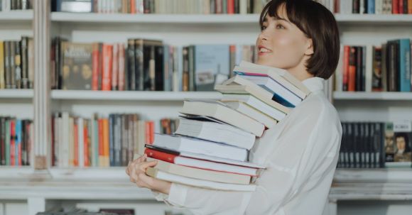 E-Readers - Woman in White Long Sleeve Shirt Reading Books