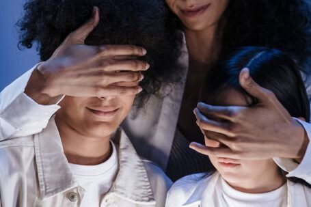 Parental Control Streaming - Mother covering eyes of her children with hands against internet content on digital pad