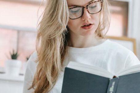 Smart Kitchen Appliances - Focused woman reading book in kitchen