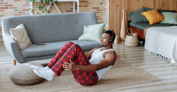 Fitness Gadgets - A Man Exercising while Wearing Headphones