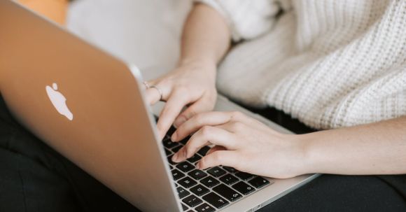 Smart Bedroom Gadgets - Crop woman typing on laptop on bed