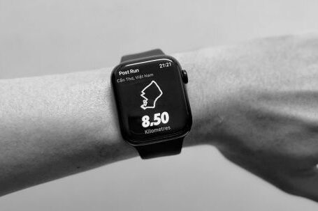 Smartwatches - A black and white image of a person's hand on an apple watch