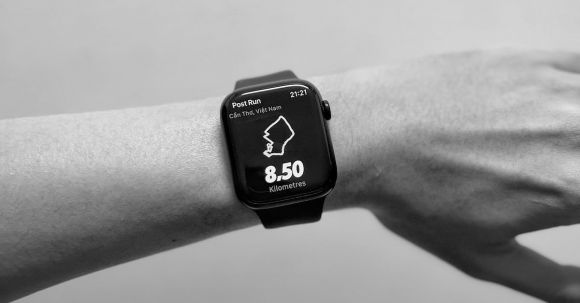 Smartwatches - A black and white image of a person's hand on an apple watch